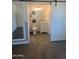 This bathroom features new light fixtures, white cabinets, wood-style flooring, and a sliding barn door at 3728 E Grove Ave, Mesa, AZ 85206