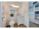 Bathroom with a bright vanity, tile accent wall, and walk-in closet at 3728 E Grove Ave, Mesa, AZ 85206