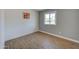 Clean bedroom with an updated look features wood floor and a window allowing natural light at 3728 E Grove Ave, Mesa, AZ 85206
