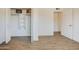 A bedroom with wood floor and open closet with shelves offers a space for organization at 3728 E Grove Ave, Mesa, AZ 85206
