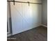 Charming bedroom features a decorative sliding barn door and modern flooring at 3728 E Grove Ave, Mesa, AZ 85206