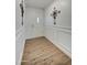 Inviting entryway features wood-look flooring, paneled walls, decorative wall art, and a bright front door at 3728 E Grove Ave, Mesa, AZ 85206