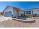 Charming single-story home with a stone facade, well-maintained landscaping, and attached garage under a clear blue sky at 3728 E Grove Ave, Mesa, AZ 85206