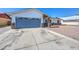 Exterior view showcasing an attached garage and stone facade leading to the front entrance of this single-story home at 3728 E Grove Ave, Mesa, AZ 85206