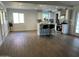 Bright kitchen with white cabinets, stainless steel appliances, kitchen island, and wood floor at 3728 E Grove Ave, Mesa, AZ 85206