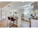 Bright kitchen with stainless steel appliances, center island, and wood-look floors, perfect for modern living at 3728 E Grove Ave, Mesa, AZ 85206