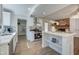 Bright, updated kitchen with stainless steel appliances, a center island, and ample cabinet space with modern finishes at 3728 E Grove Ave, Mesa, AZ 85206