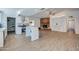 Large open kitchen featuring modern appliances, a spacious island with seating, and a brick fireplace in the living area at 3728 E Grove Ave, Mesa, AZ 85206
