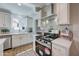 Bright, open kitchen with stainless steel appliances, white cabinets, and stone countertops at 3728 E Grove Ave, Mesa, AZ 85206