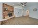 Living room with a large brick fireplace and a view to an adjacent room at 3728 E Grove Ave, Mesa, AZ 85206