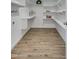 Walk-in pantry featuring custom shelves and laminate wood flooring at 3728 E Grove Ave, Mesa, AZ 85206