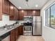 Efficient kitchen with stainless steel appliances, dark wood cabinets, and practical layout for cooking and storage at 4354 N 82Nd St # 183, Scottsdale, AZ 85251