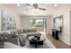 Inviting living room with plush gray sofa, stylish decor, and bright natural light from the sliding glass doors to the patio at 4354 N 82Nd St # 183, Scottsdale, AZ 85251