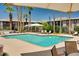 A large swimming pool at the property surrounded by lounge chairs and shaded seating areas at 4354 N 82Nd St # 183, Scottsdale, AZ 85251