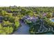 Aerial view showcasing a beautiful property with lush landscaping and a circular driveway at 5710 E Camelback Rd, Phoenix, AZ 85018