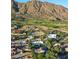 Aerial view of a home in a community close to the desert mountains and golf course at 5710 E Camelback Rd, Phoenix, AZ 85018