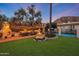 Spacious backyard with a large fountain, pool, outdoor grill and outdoor dining area at 5710 E Camelback Rd, Phoenix, AZ 85018