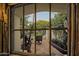 Charming backyard view through decorative window features a tranquil patio at 5710 E Camelback Rd, Phoenix, AZ 85018