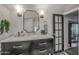 Bright bathroom featuring a marble vanity, black cabinets, and unique fixtures and finishes for a modern design at 5710 E Camelback Rd, Phoenix, AZ 85018