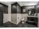 Modern bathroom with a dark accent wall, tiled shower, and updated vanity with a mirror at 5710 E Camelback Rd, Phoenix, AZ 85018