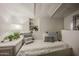 Cozy bedroom featuring textured walls, built-in niche, and comfortable daybed with decorative pillows at 5710 E Camelback Rd, Phoenix, AZ 85018