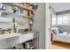 Well-organized pantry with storage, subway tile backsplash, and stainless steel sink at 5710 E Camelback Rd, Phoenix, AZ 85018