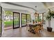 Dining room with multiple French door exits that provide an abundance of natural light and courtyard views at 5710 E Camelback Rd, Phoenix, AZ 85018
