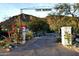 Scenic entrance to Casa Manana with desert landscape, flowers, and mountain views at 5710 E Camelback Rd, Phoenix, AZ 85018