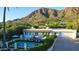 Beautiful home with a pool, manicured lawn, and stunning mountain views at 5710 E Camelback Rd, Phoenix, AZ 85018