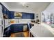 Charming kitchen with deep blue cabinets, stainless steel appliances, and tile countertops at 5710 E Camelback Rd, Phoenix, AZ 85018
