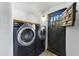 Large laundry room featuring an updated washer and dryer and a unique door at 5710 E Camelback Rd, Phoenix, AZ 85018