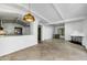 Bright living room with a stone fireplace and tiled floors under a beamed ceiling at 5710 E Camelback Rd, Phoenix, AZ 85018