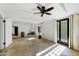 Expansive living room with terracotta tile, fireplace, and bright natural light from the multiple windows and doors at 5710 E Camelback Rd, Phoenix, AZ 85018