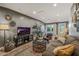 Comfortable living room with a large TV, stylish rug, and cozy seating arrangement at 5710 E Camelback Rd, Phoenix, AZ 85018