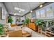 Open living room with modern furniture, skylights, and decorative plants at 5710 E Camelback Rd, Phoenix, AZ 85018