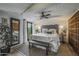 Bright main bedroom with a decorative headboard, dark wood accents, and French doors to a private balcony at 5710 E Camelback Rd, Phoenix, AZ 85018