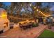 Charming outdoor patio with dining table, built-in seating, an outdoor grill and string lights at 5710 E Camelback Rd, Phoenix, AZ 85018