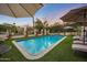 Inviting pool area with lounge chairs and umbrellas, perfect for enjoying the sun at 5710 E Camelback Rd, Phoenix, AZ 85018