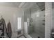 The bright white shower features beautiful tile work, a shower seat and a glass door at 5710 E Camelback Rd, Phoenix, AZ 85018