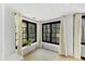 Bright sun room with large black-framed windows, tiled floors, and white wall accents at 5710 E Camelback Rd, Phoenix, AZ 85018