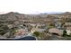 Expansive aerial view of a desert neighborhood nestled in the rolling hills and featuring homes with solar panels at 6206 W Buckhorn Trl, Phoenix, AZ 85083