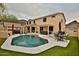 Beautiful backyard featuring a pool, patio, outdoor kitchen and well-manicured lawn at 6206 W Buckhorn Trl, Phoenix, AZ 85083