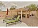 Relaxing backyard oasis featuring a covered patio, lounge chairs, and lush landscaping at 6206 W Buckhorn Trl, Phoenix, AZ 85083