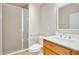 Bathroom featuring a shower with a frosted glass door, a toilet, and a wooden vanity at 6206 W Buckhorn Trl, Phoenix, AZ 85083