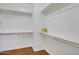 Walk-in closet featuring wooden floors, white walls and shelves, and a closet rod at 6206 W Buckhorn Trl, Phoenix, AZ 85083