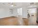 Spacious living room featuring hardwood floors, a window with blinds and a ceiling fan for added comfort at 6206 W Buckhorn Trl, Phoenix, AZ 85083