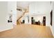 Bright living room featuring high ceilings, wood floors, and an elegant staircase at 6206 W Buckhorn Trl, Phoenix, AZ 85083