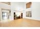 Open living room with neutral colors, wood-look flooring, large windows and easy access to the backyard patio at 6206 W Buckhorn Trl, Phoenix, AZ 85083