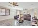 Spacious living room features tile flooring, wet bar, ceiling fans, and comfortable seating at 6206 W Buckhorn Trl, Phoenix, AZ 85083