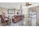 Great living room features tile flooring, ceiling fan, screen, and access to the patio and pool at 6206 W Buckhorn Trl, Phoenix, AZ 85083